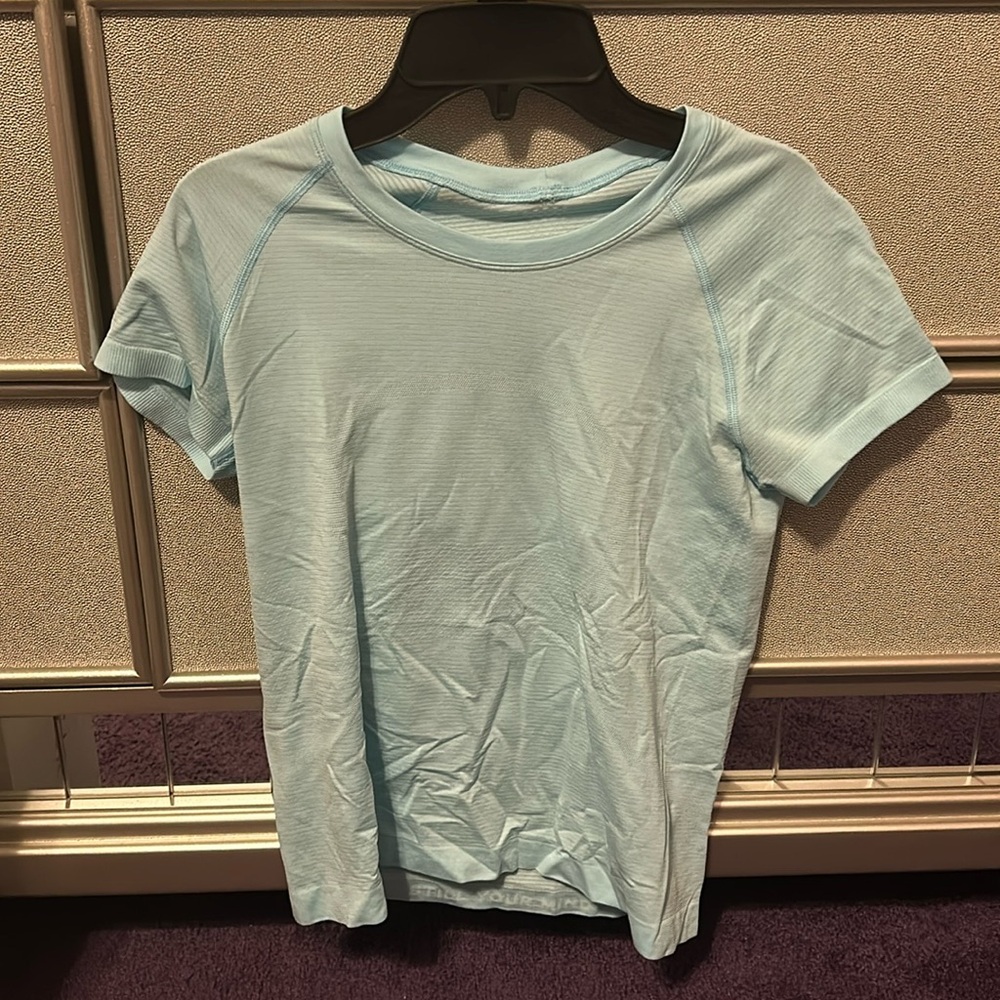 Light blue lulu swiftly short sleeve top . It’s the shorter length style